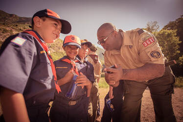 Picture Scout Leader shows phone to Scouts